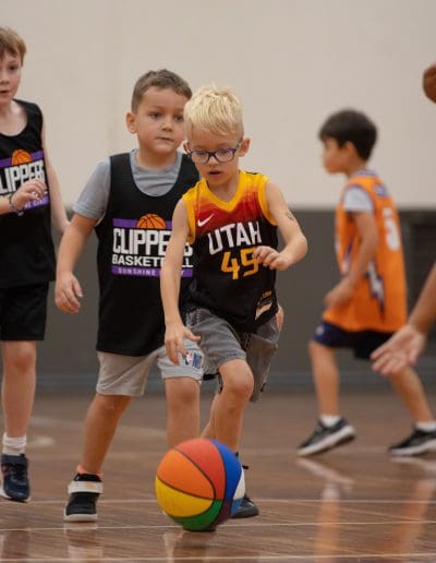 Suncoast Clippers Basketball Clippers Basketball Mini Clippers young boy with glasses dribbling scaled