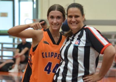Suncoast Clippers Basketball Clippers Basketball Refs referee with a young woman player on court scaled