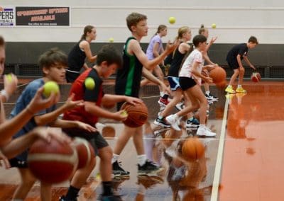 Suncoast Clippers Basketball Clippers Basketball camps young players doing dribbling drills along the sidelines